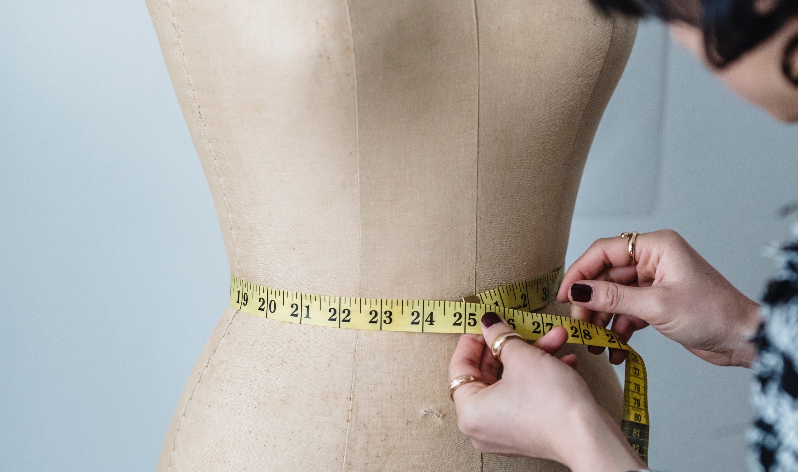 tape measure around a fitting mannequin