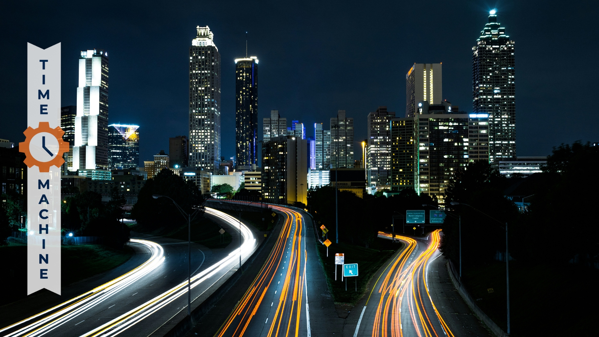 Night Skyline with streaks of car lights on a highway