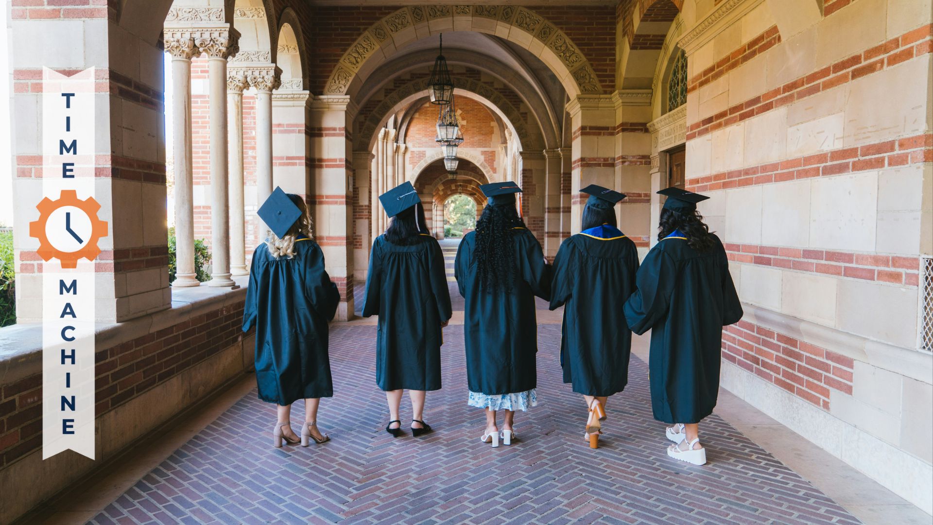 graduating students in a outdoor hallway in caps and gowns